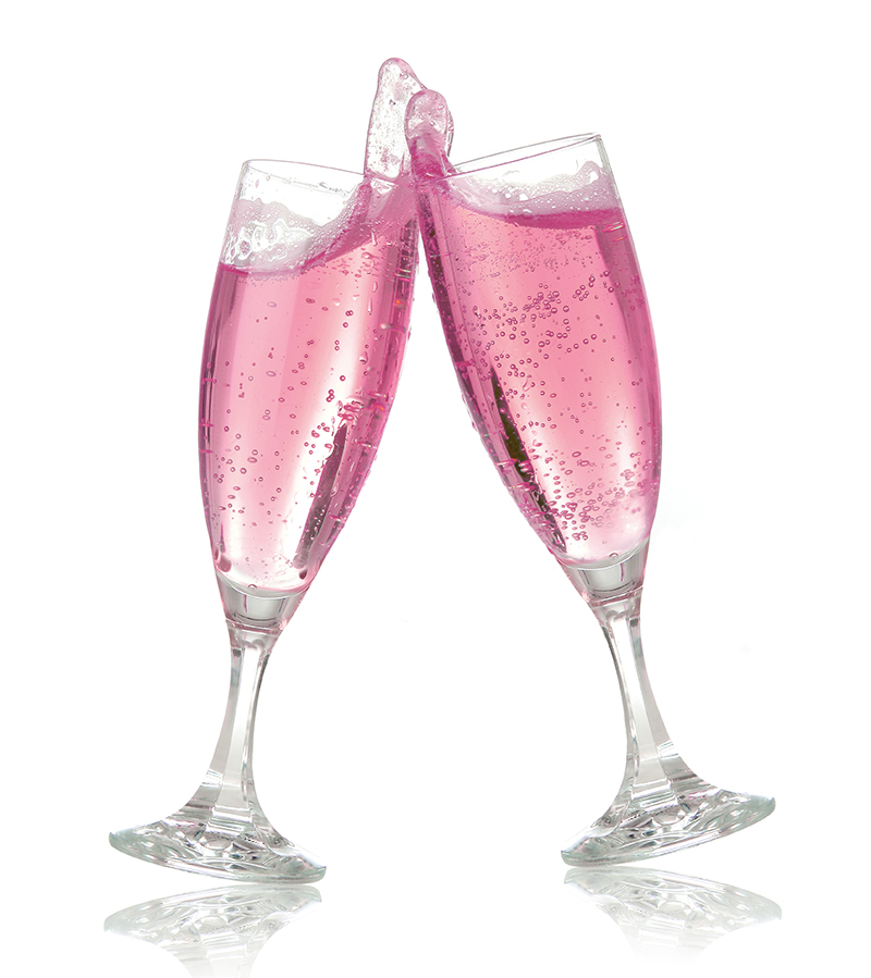Pair of champagne flutes making a toast. Champagne splash